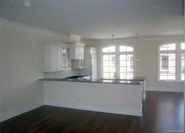 Eat in kitchen with long bar counter facing the dining area & living room... just add your bar stools...