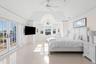 Bedroom featuring access to exterior, a ceiling fan, french doors, and vaulted ceiling