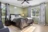 Get cozy in this modern primary bedroom suite. It features lots of natural light, an open walk-in closet, and a secret entry into the living room.