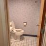 Bathroom with baseboards, toilet, and tile patterned flooring