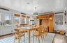 Dining room with ornamental molding and hardwood / wood-style flooring