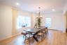 Dining space with ornamental molding, a chandelier, and light wood-style floors