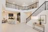 Virtually staged front entrance with view into the kitchen
