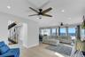 Living room featuring light wood finished floors, recessed lighting, and stairway