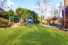 Back yard with play set and shed.