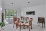 Bright dining area featuring a three-panel window, recessed ceiling lighting, and light-toned wall-to-wall carpeting