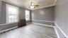 Spare room featuring crown molding, radiator, ceiling fan, and light wood-type flooring