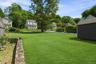 Stretching beyond the garage, the grounds reveal a generous, green landscape with endless possibilities.