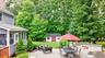 Expansive paver patio with a built-in fire pit and a stone retaining wall