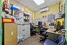 Office with wood finished floors, electric panel, a paneled ceiling, and a wall unit AC