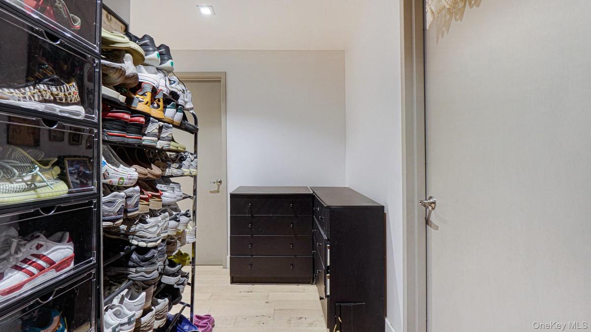 Walk in closet featuring light wood-style floors