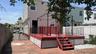 Backyard - Red-stained wood deck with black metal railings and steps