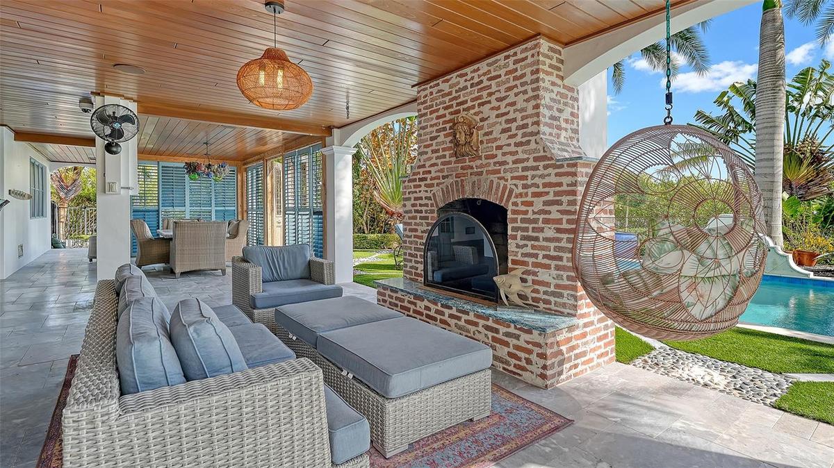 Covered outdoor lounge with fireplace