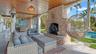 Covered outdoor lounge with fireplace