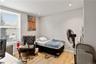 Bedroom featuring light wood-finish flooring, recessed lighting, and a window with blinds