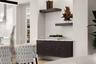 The dining room has a custom built-in buffet cabinetry with shelving, wallpaper accents, and recessed lighting.