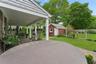 Fenced backyard with an outdoor structure, outdoor dining space, and a deck