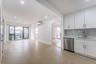 Kitchen with white cabinets, stainless steel dishwasher, recessed lighting, light wood finished floors, and open floor plan
