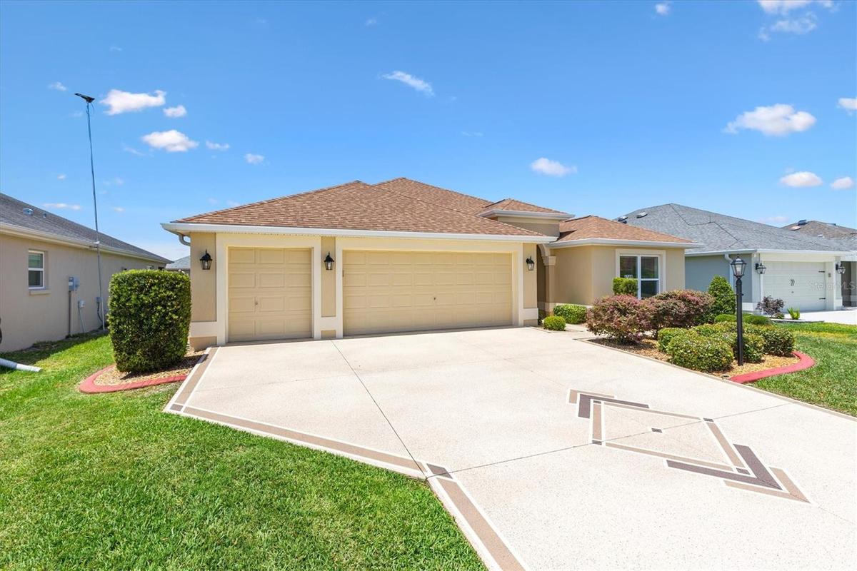 Extended 2 car plus golf cart garage with wide driveway.