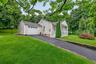 Charming curb appeal with welcoming front porch and newly paved driveway.