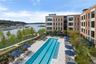 Seasonal outdoor swimming pool surrounded by a spacious sun deck, comfortable lounge chairs, and shaded umbrellas