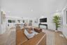 Open-concept living area featuring wood-finish flooring, recessed lighting, and expansive windows