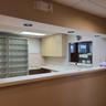 Kitchen featuring open shelves, light countertops, and a paneled ceiling