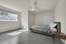 Bedroom featuring ceiling fan, a closet, baseboards, and wood finished floors