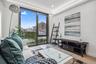Living room with a view of city, healthy amount of natural light, wood finished floors, recessed lighting, and baseboards
