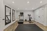This bright, professional home gym features performance flooring, expansive mirrors, and natural light. It’s an energizing, turnkey space designed for