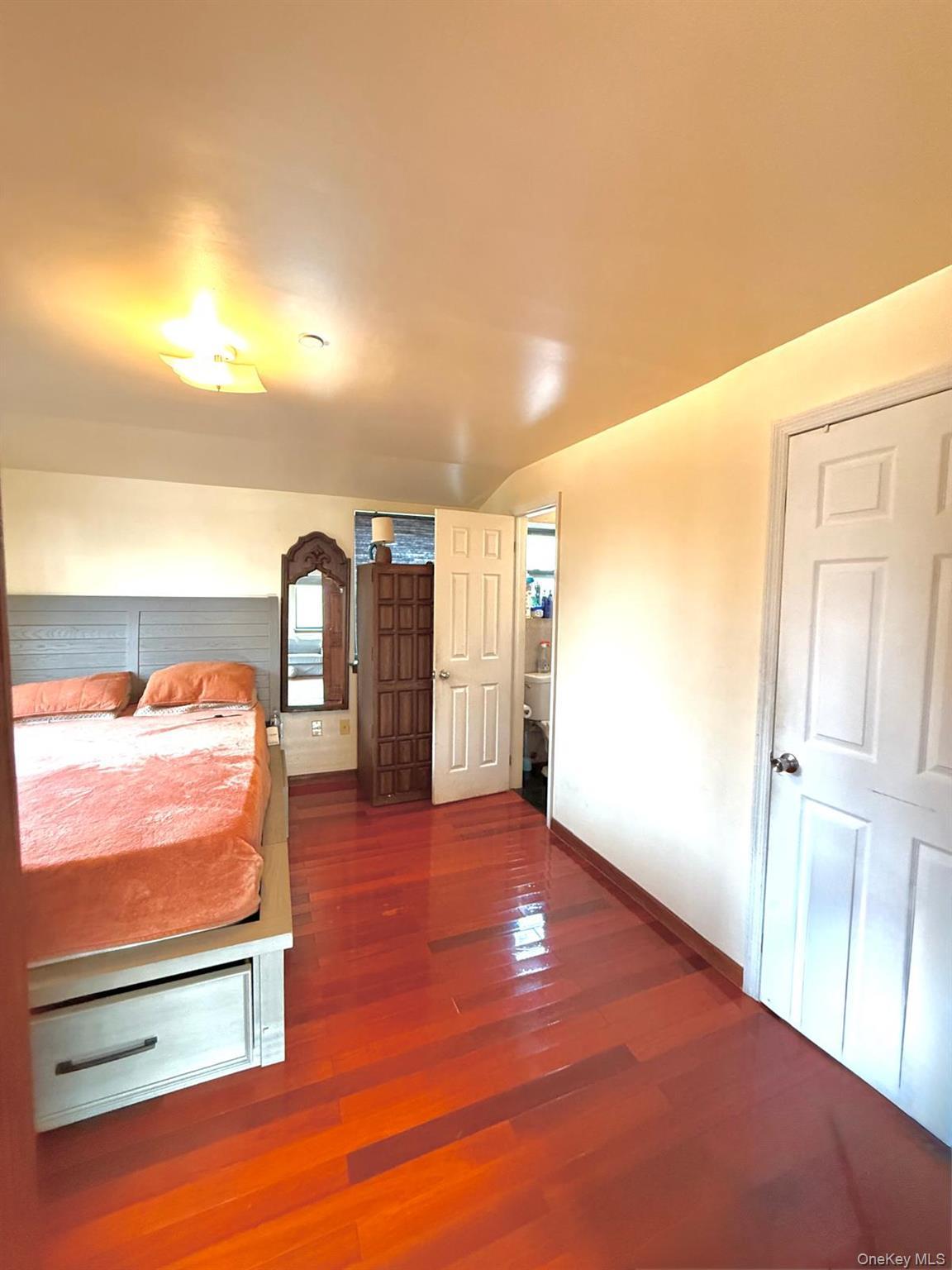 Master Bedroom with dark wood finished floors and baseboards