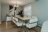 Dining space with a chandelier, a baseboard radiator, and light hardwood / wood-style floors