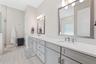 Dual sinks and oversized vanity along with a separate and private water closet.