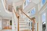 Grand Stairway with crown molding, recessed lighting, and a towering ceiling