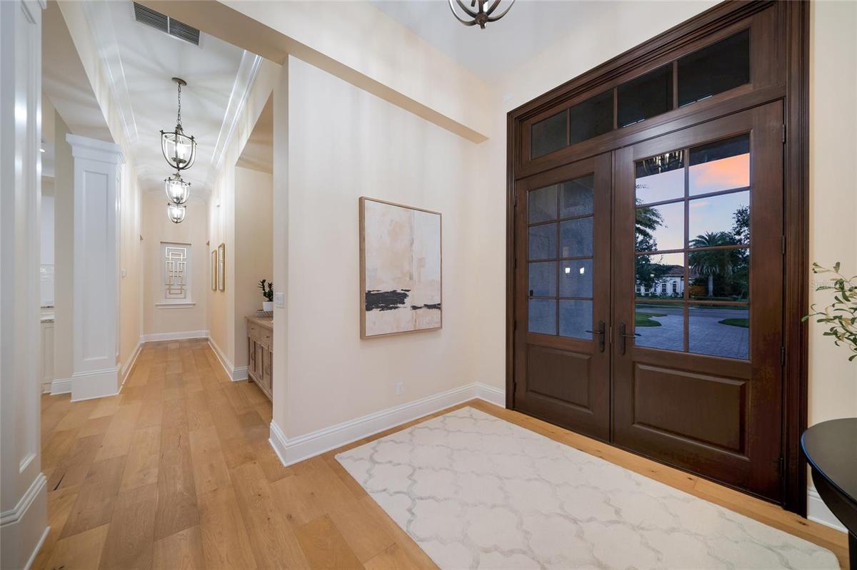 Double door entry with elegant hallway on both sides