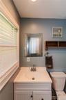 White vanity with integrated sink, and polished chrome faucet