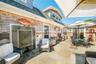 View of patio with outdoor dining area and a grill