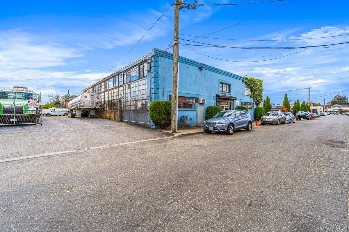 View of property featuring uncovered parking