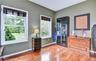 Office featuring wood flooring, two windows and french doors