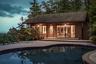 Pool overlooking pool house and deck