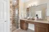 Custom stonework in the large walk in shower with dual shower heads