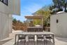 Wooden deck with a pergola and outdoor dining space