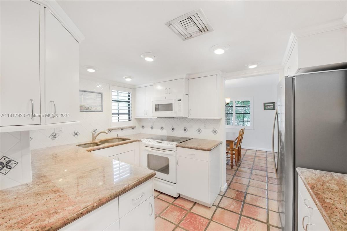 Kitchen with natural light, opening windows and access to your own washer and dryer.