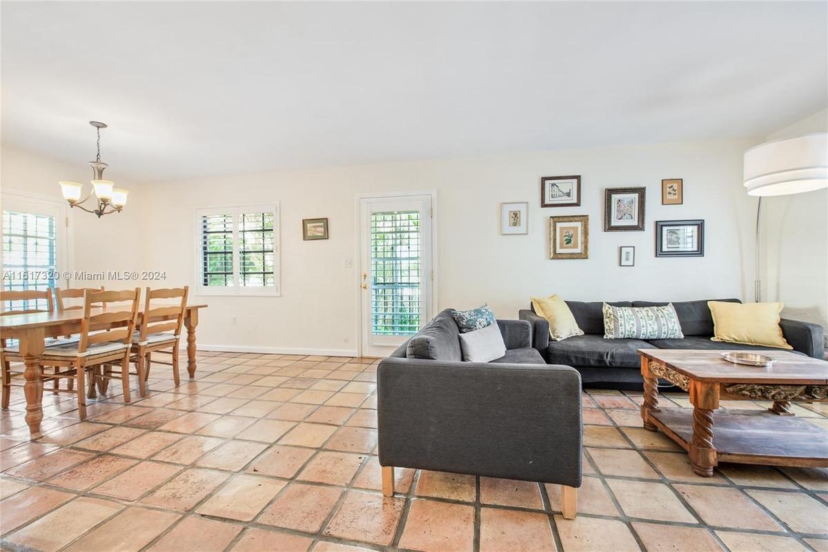 Elegant and formal dining room with access to kitchen, balcony and patio.