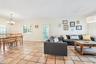Elegant and formal dining room with access to kitchen, balcony and patio.