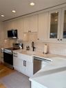 Kitchen with white cabinetry, sink, stainless steel appliances, and light hardwood / wood-style floors