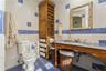 Bathroom with tile walls, toilet, tile patterned floors, and sink