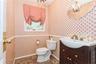 Bathroom featuring an inviting chandelier, vanity, and toilet