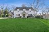 Cape cod-style house with a front lawn