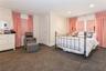 Carpeted bedroom with ornamental molding
